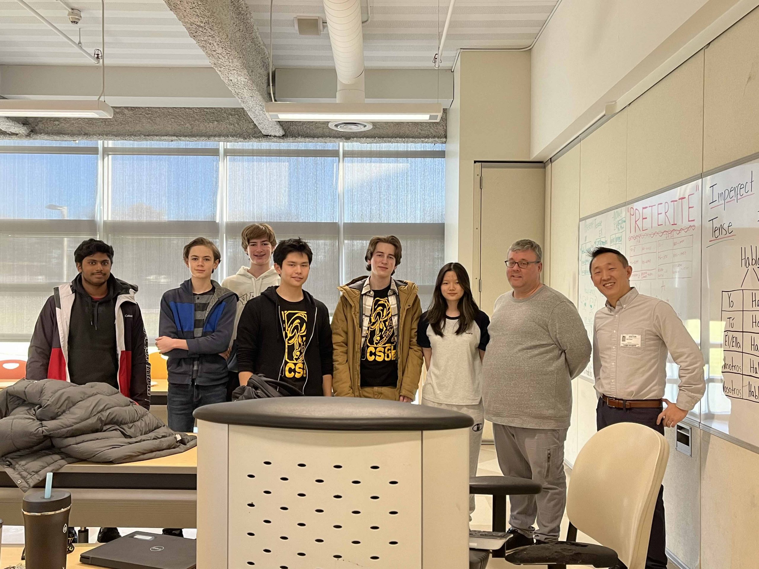 Students with Associate Professor Wei Chen after an introduction to generative AI at the Academy of Information Technology and Engineering in Stamford.